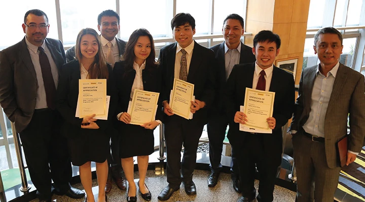 Group of students holding certificate of attendance for a business events