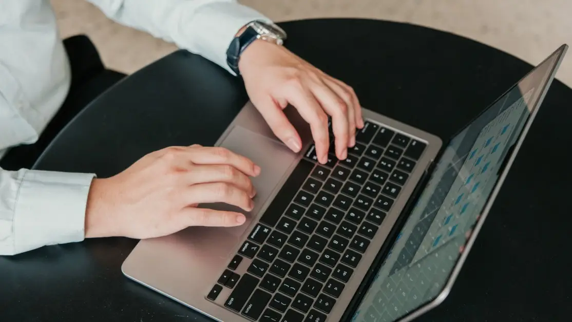 Corporate hands assessing laptop for learning