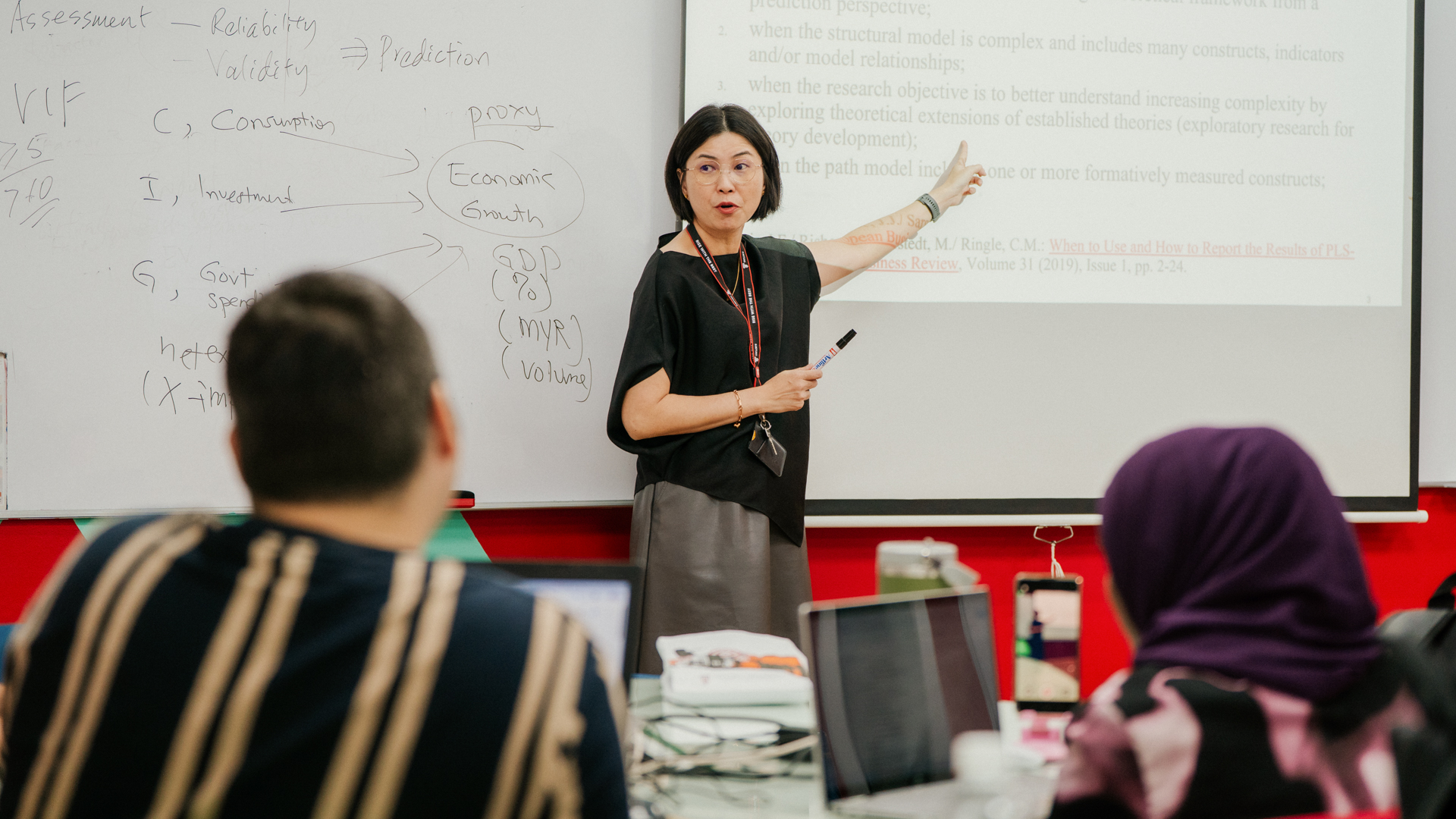 Taylor’s lecturer delivering an interactive business class using visual presentations
