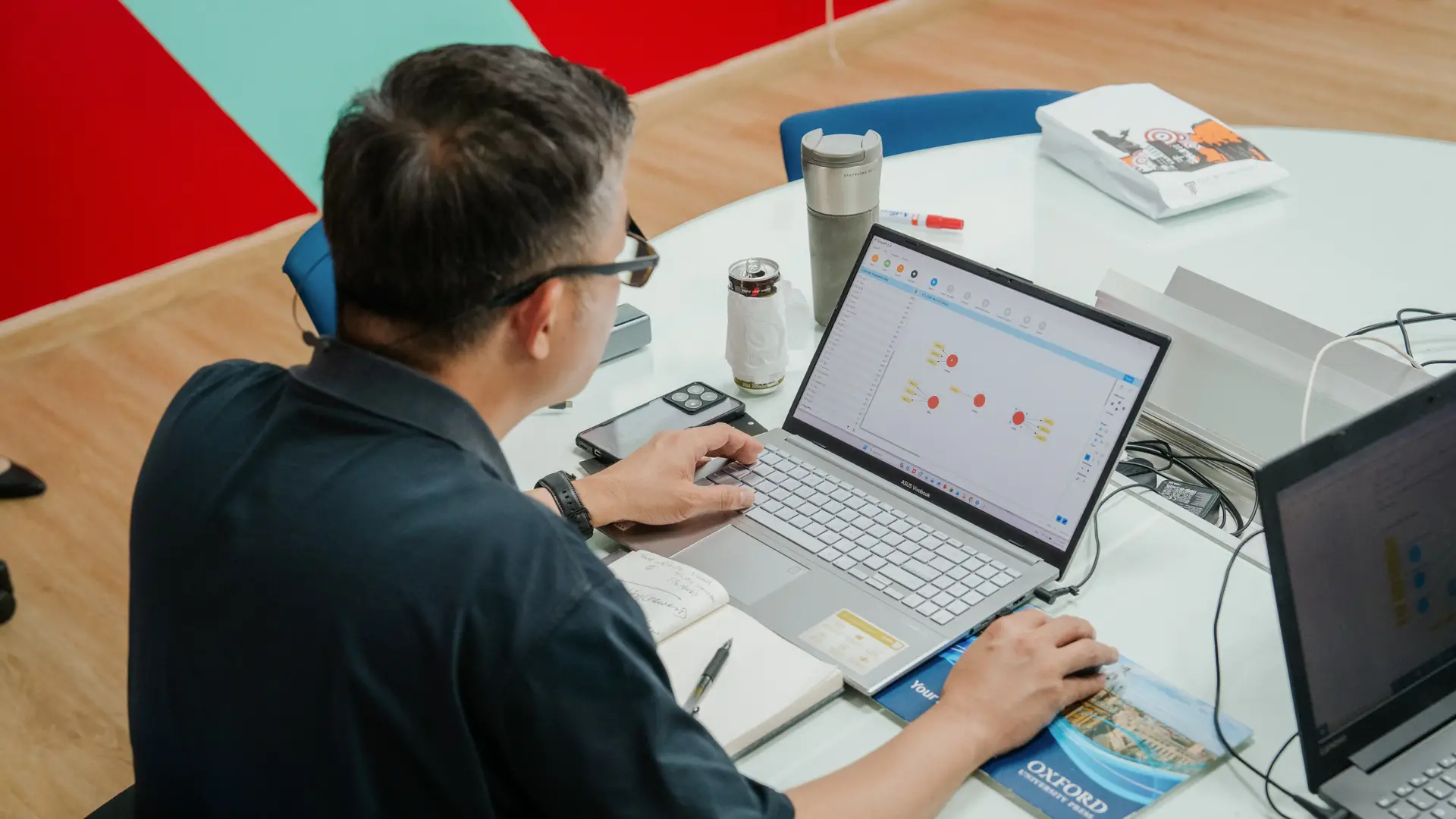 Doctor of Business Administration student analysing business data and models on a laptop