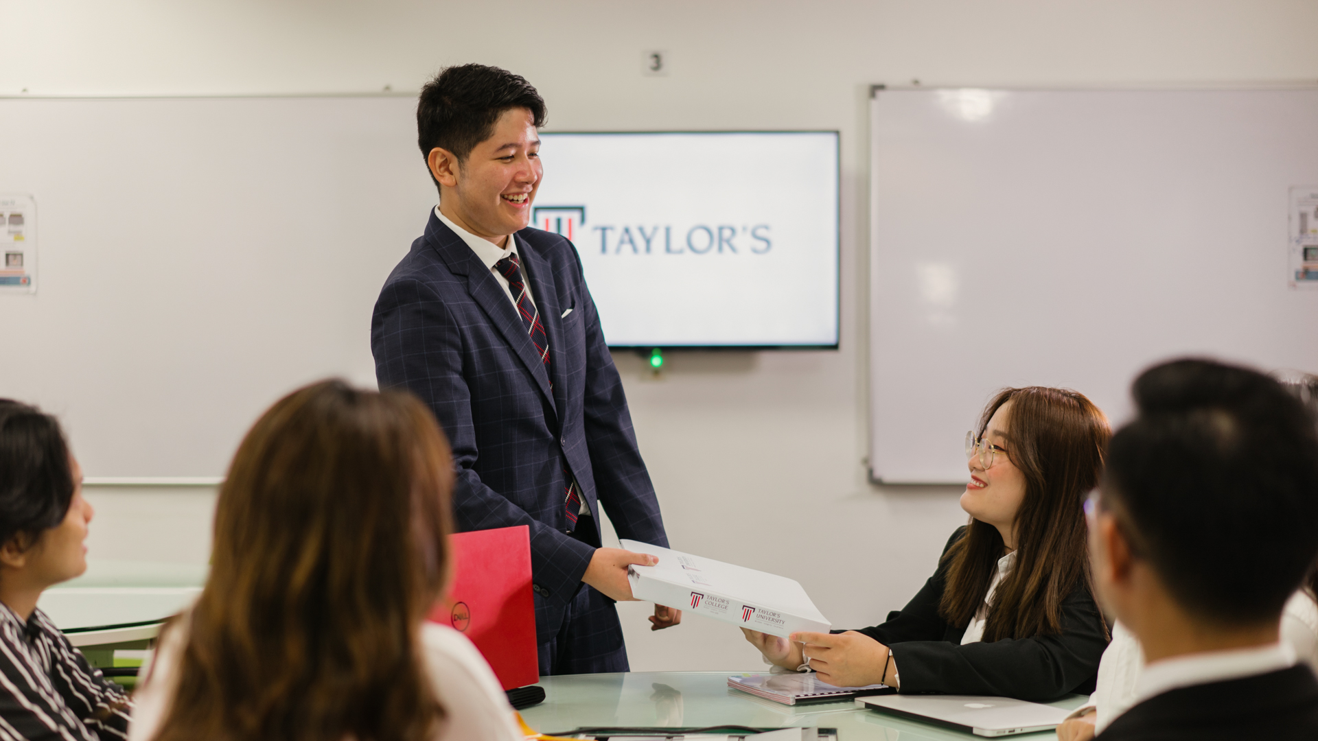 Taylor's student presenting project in front of classmates
