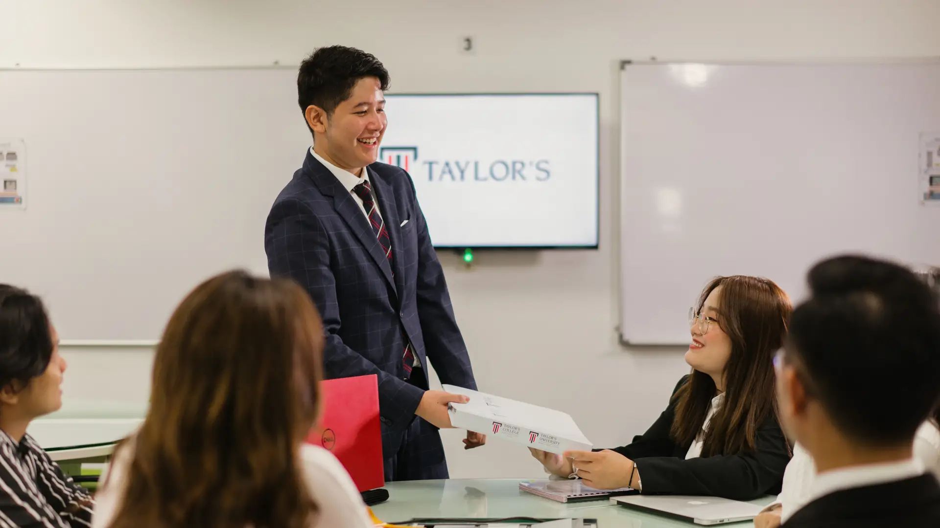 Taylor's student presenting project in front of classmates