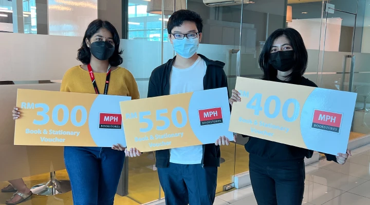 Three students holding the book vouchers for MPH Bookstores