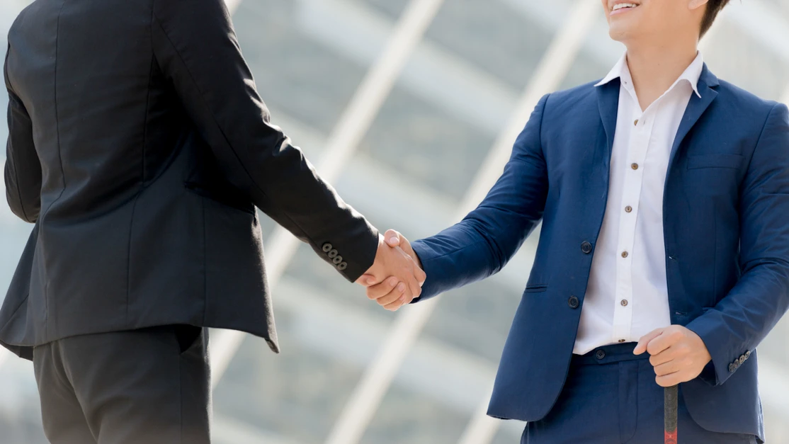 Handshake of Taylor's business lecturer and industry partners