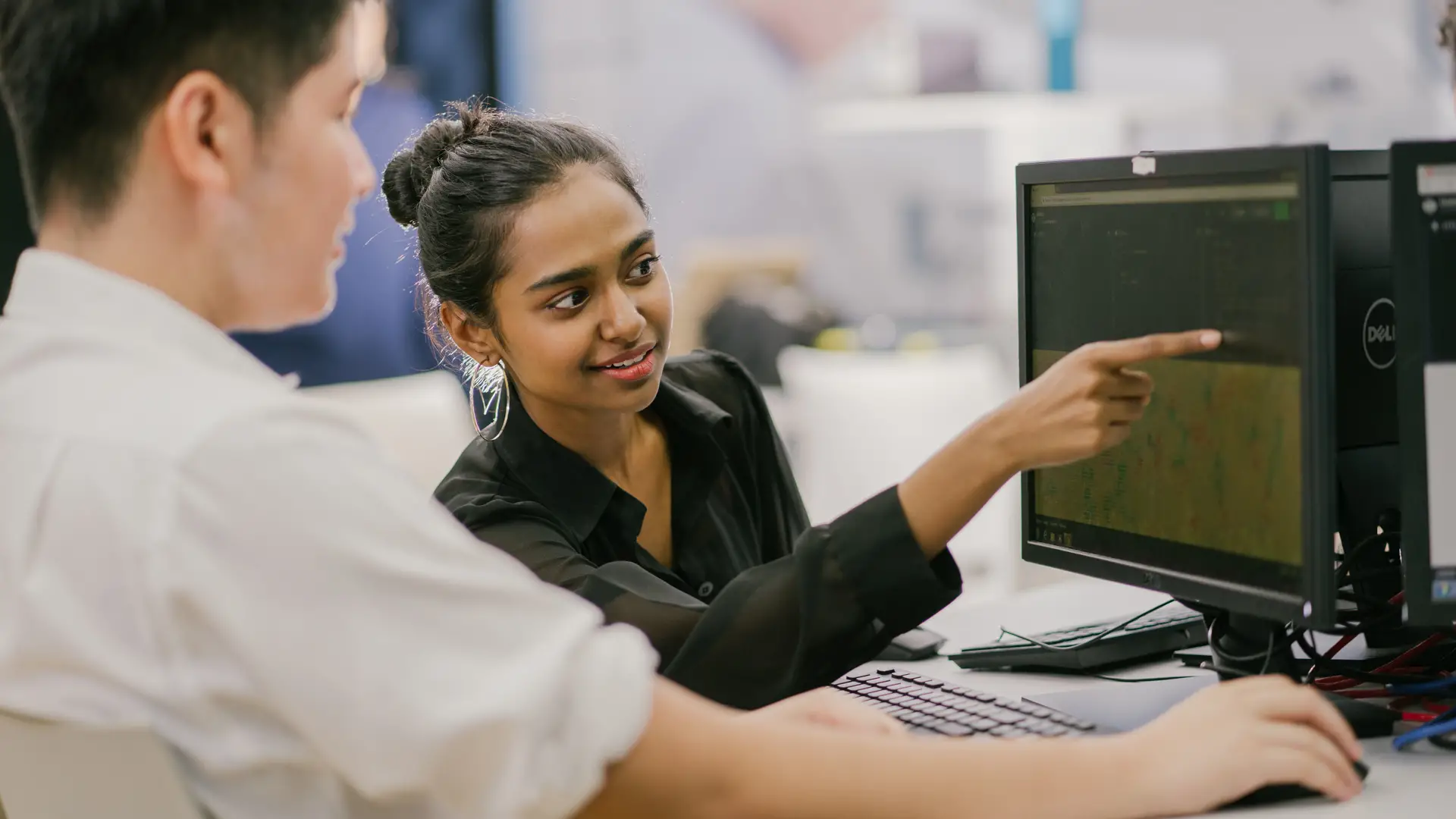 Taylor's lecturer guiding master's student during project in computer laboratory