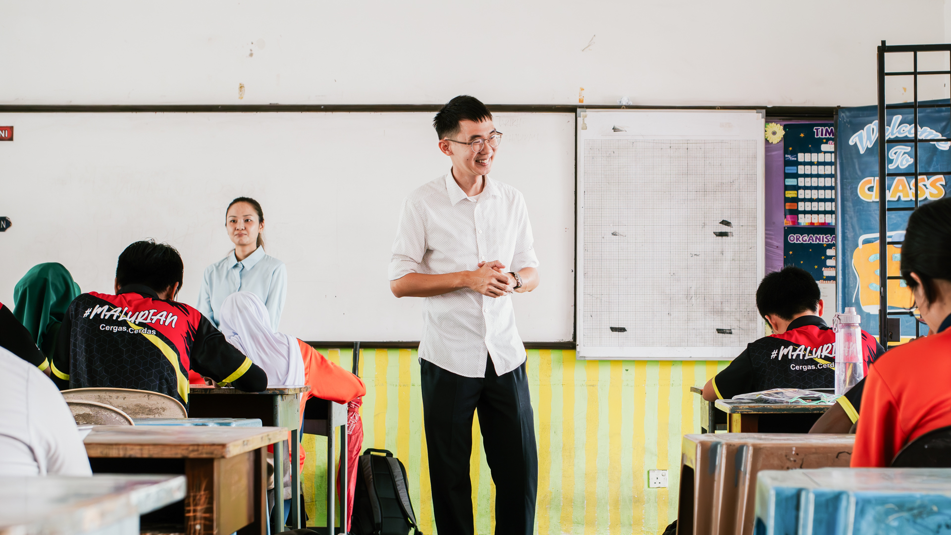 A Taylor's University lecturer leading an interactive classroom discussion with students during an engaging workshop session