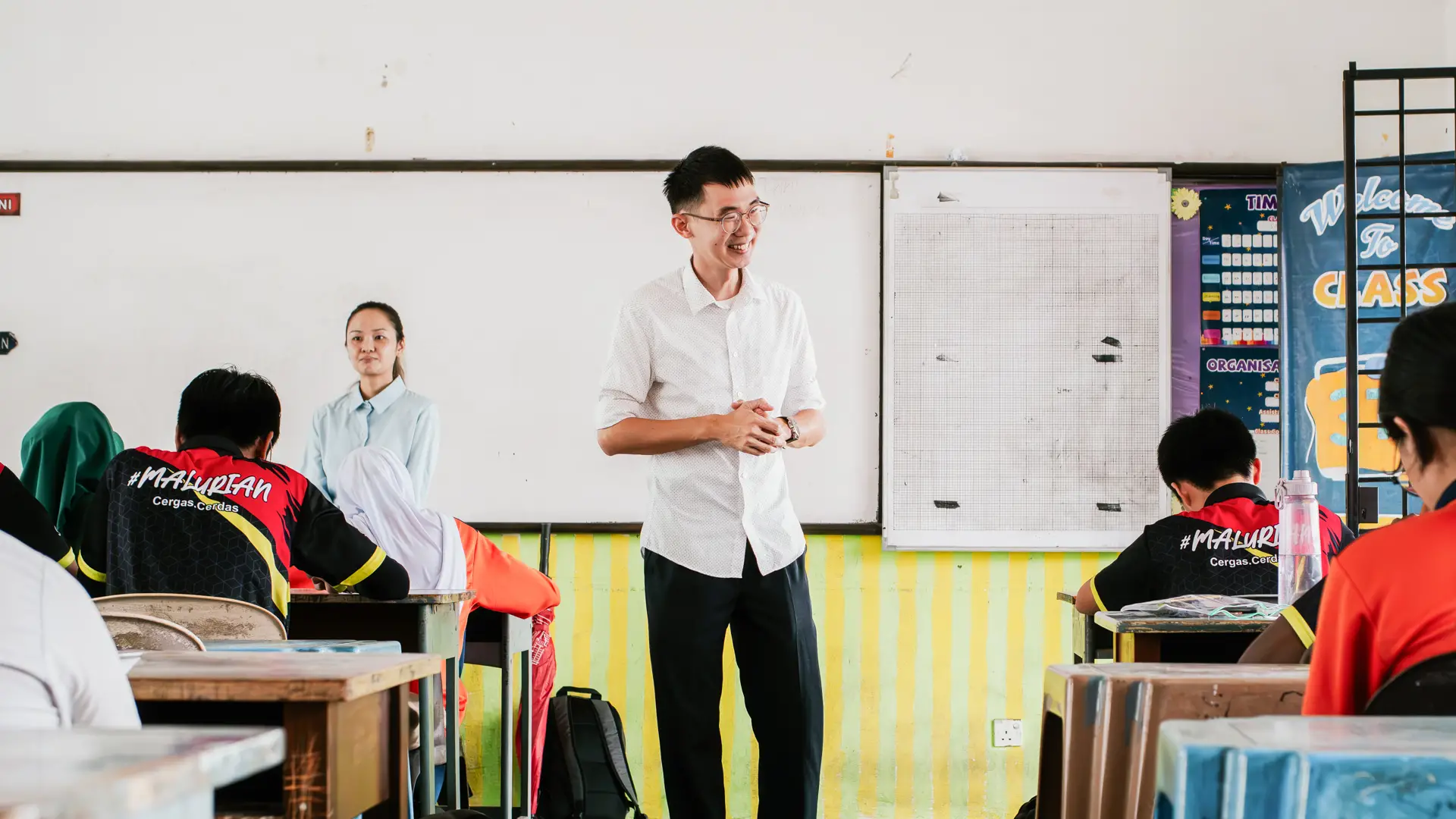 A Taylor's University lecturer leading an interactive classroom discussion with students during an engaging workshop session