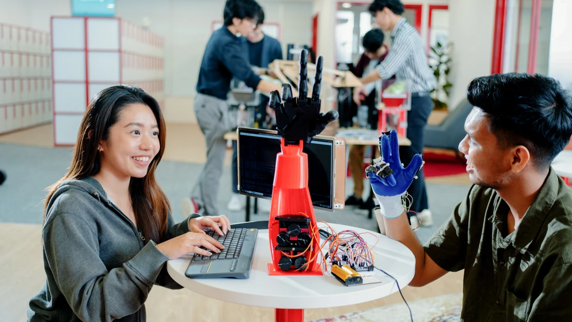 Taylor's engineering student demonstrating the robotic arm