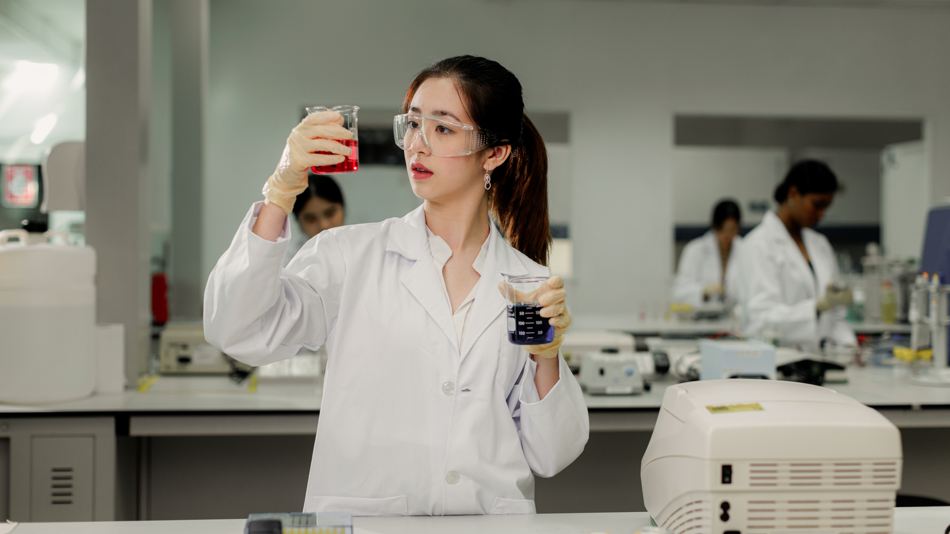 Chemical Engineering student analysing liquid samples in a modern laboratory environment