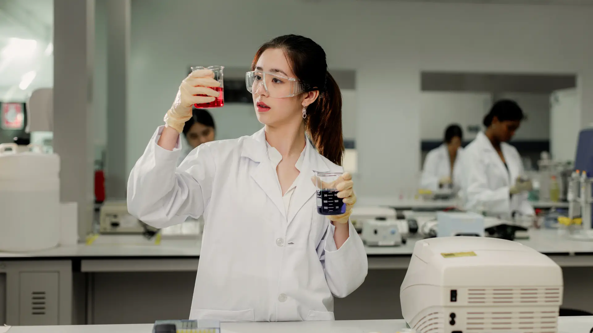 Chemical Engineering student analysing liquid samples in a modern laboratory environment
