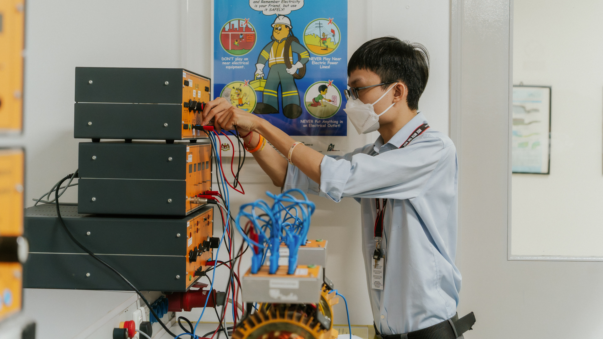Electrical and Electronic Engineering student working on wiring and circuit systems in a laboratory