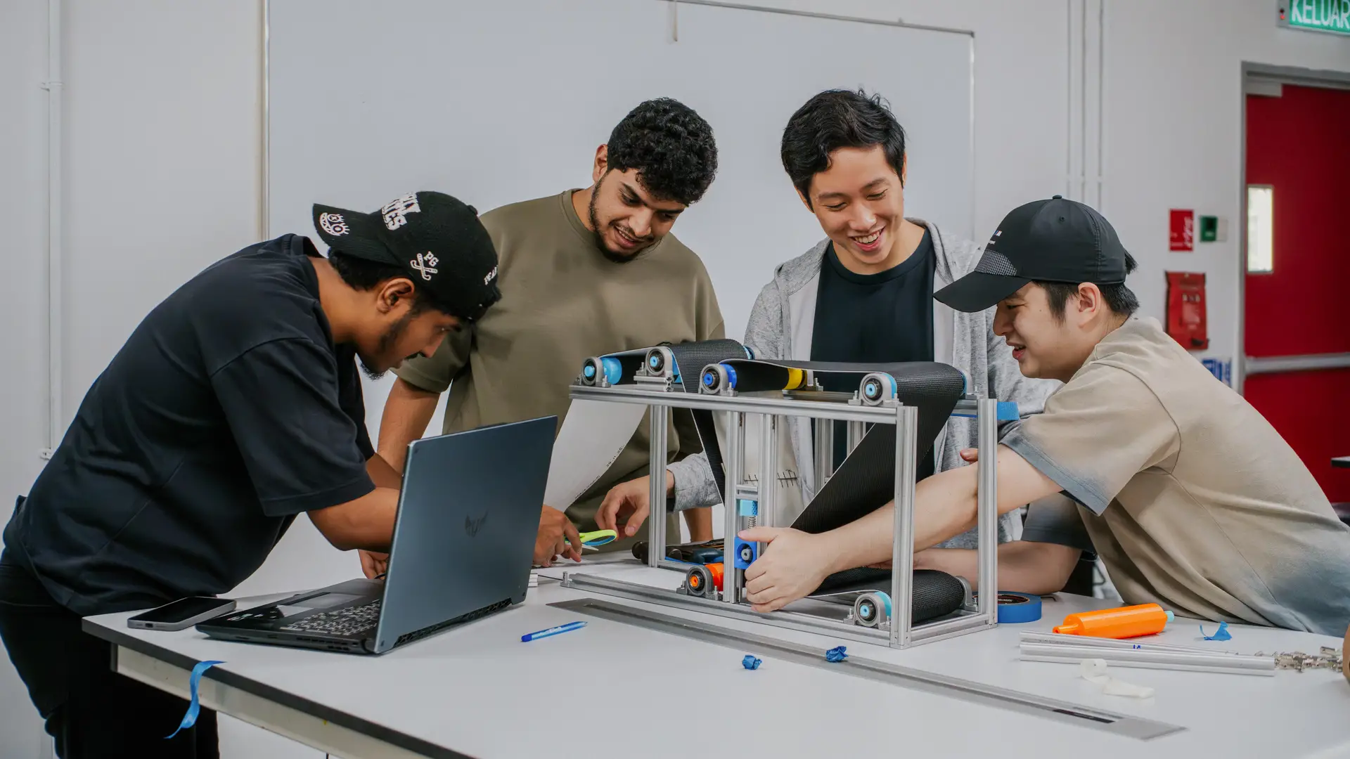 Mechanical Engineering students collaborating on a prototype development project in an engineering lab