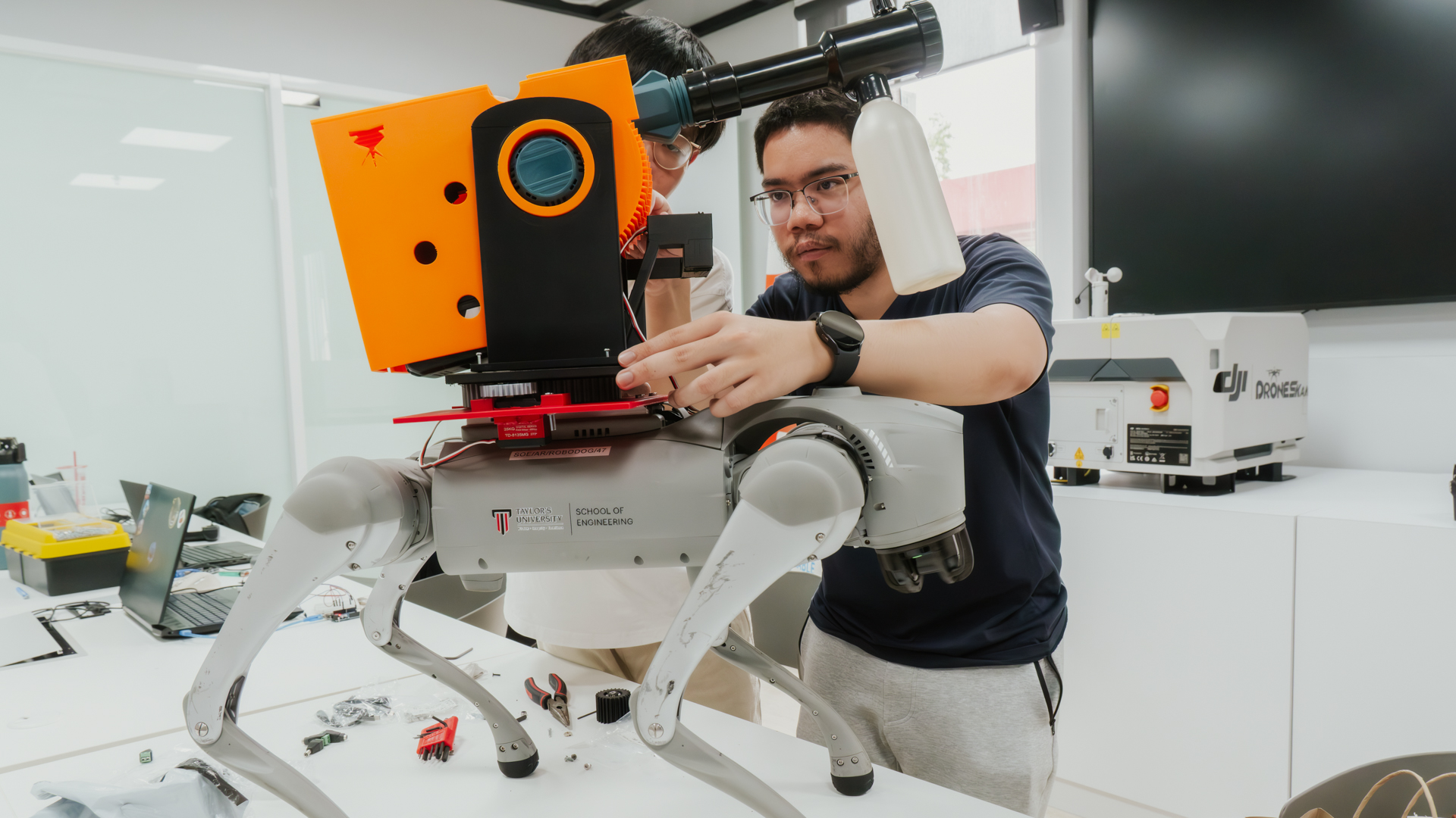Mechatronics Engineering student working on a robotics system in an advanced engineering lab