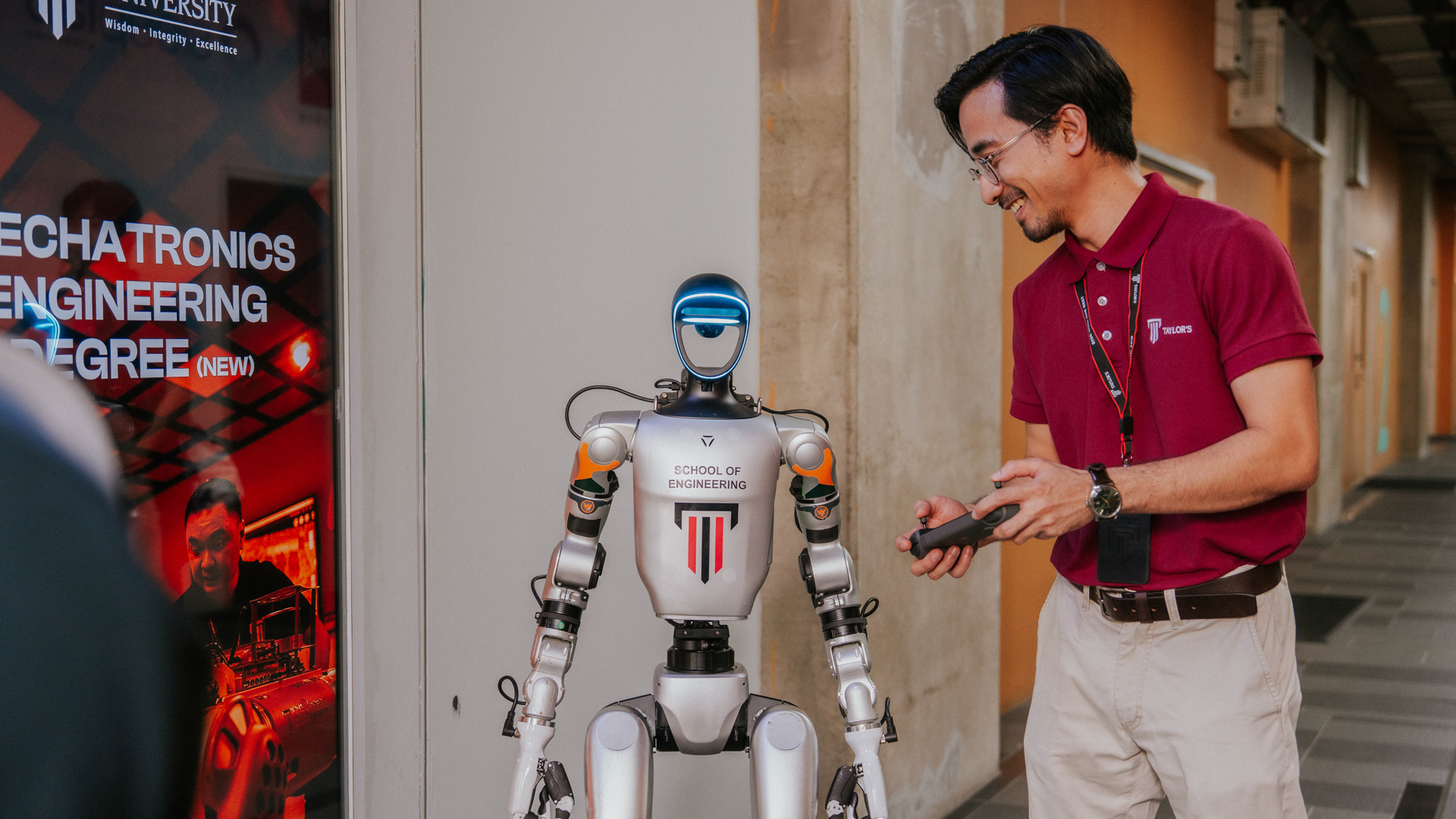 Doctor of Philosophy in Engineering candidate interacting with a humanoid robot in an advanced engineering environment