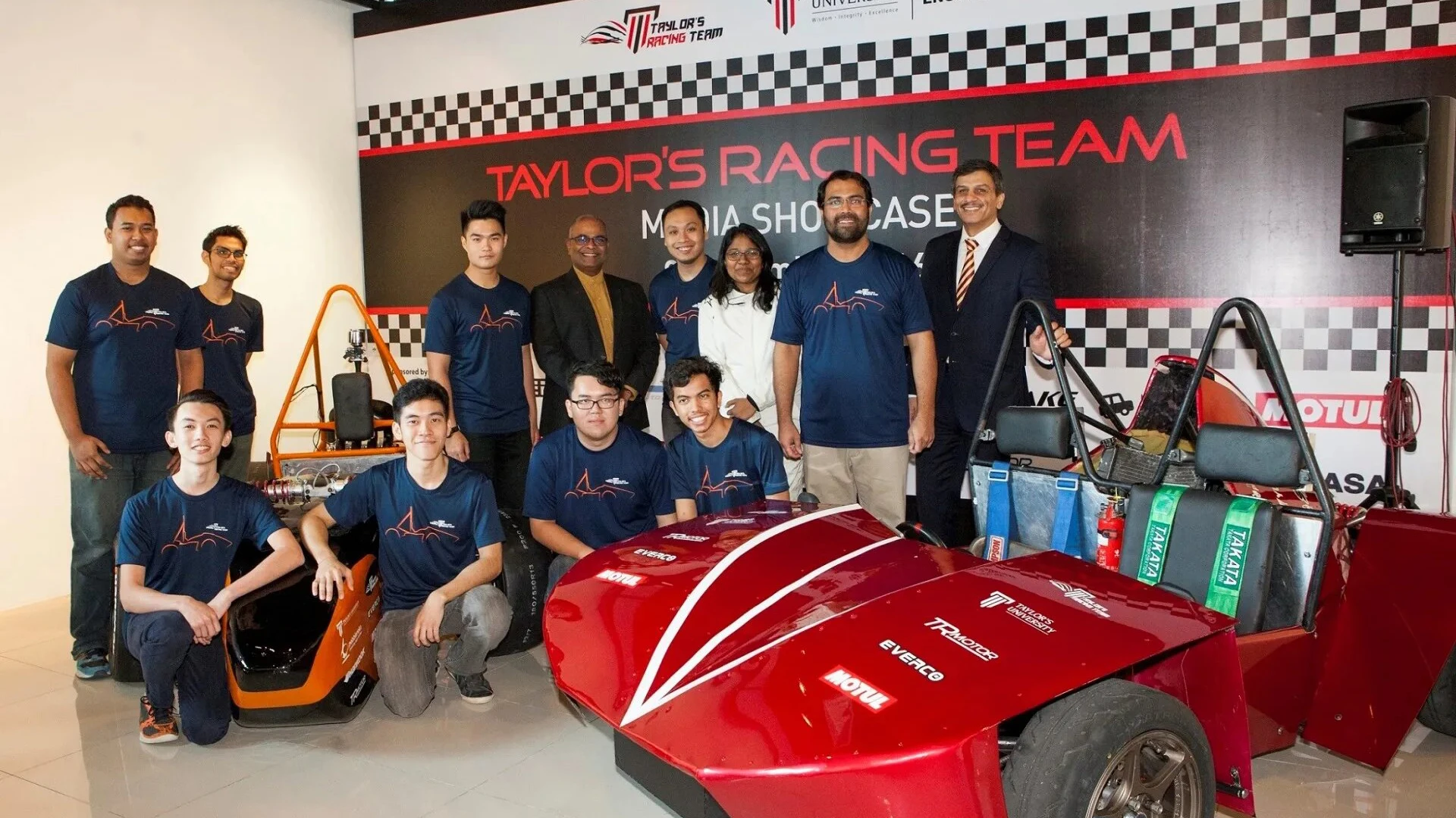 Group of engineering student in front of the racing car built