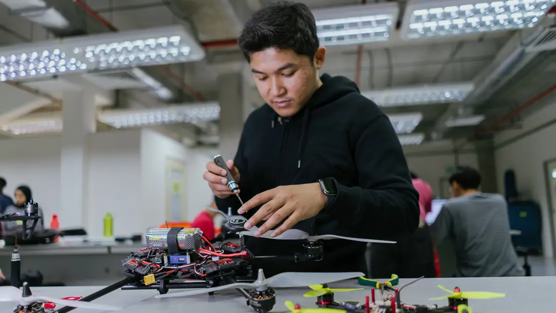 Taylor's engineering student building the model of the project