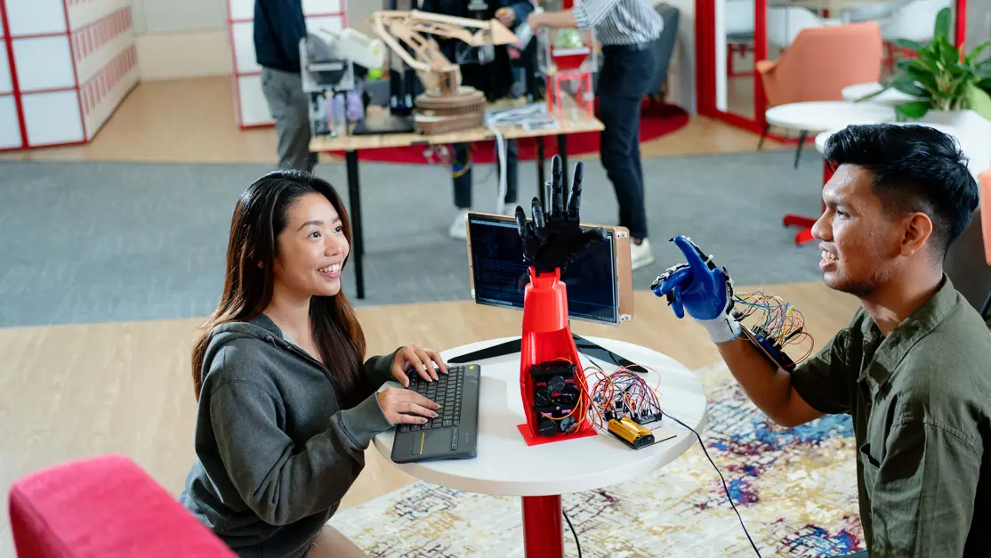 Taylor's engineering student trying on the robotic arm