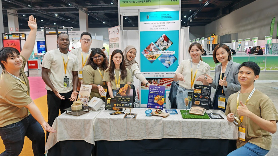 students with their booth in the international food show