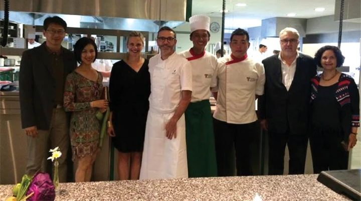 taylor's representative in a group photo with michelin-star chefs