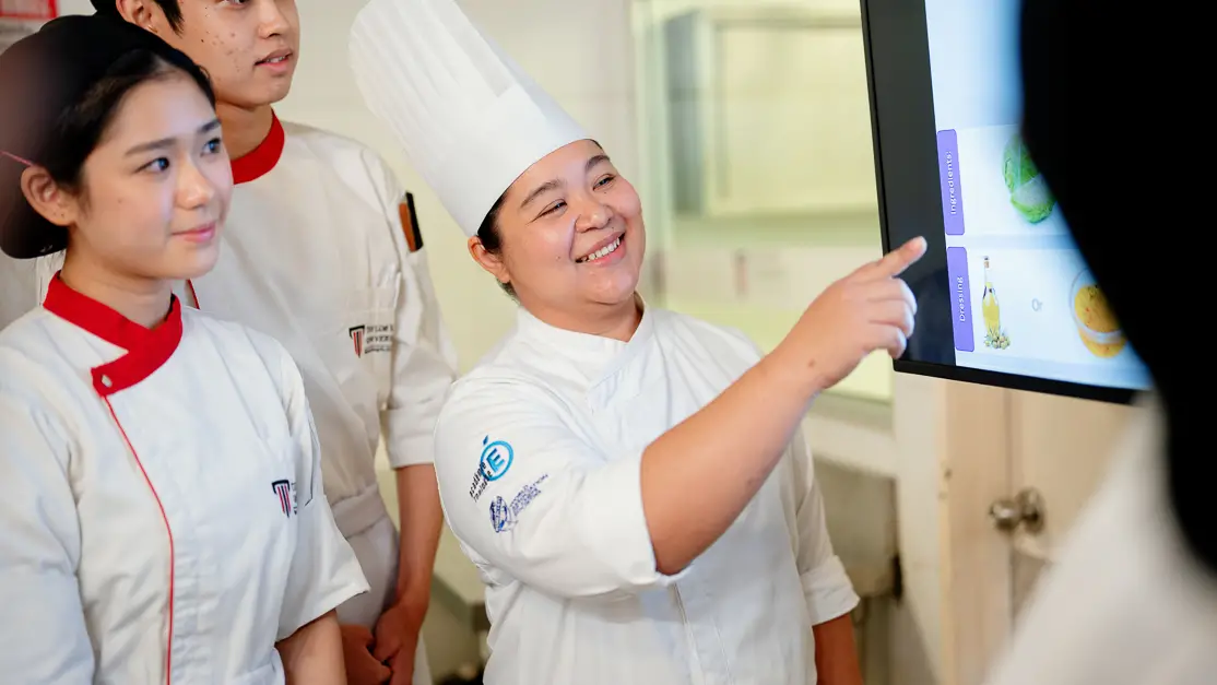 Taylor's culinary student presenting project to peers