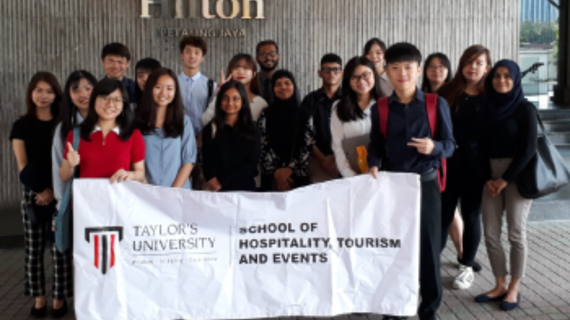 group picture in front of hilton hotel entrance
