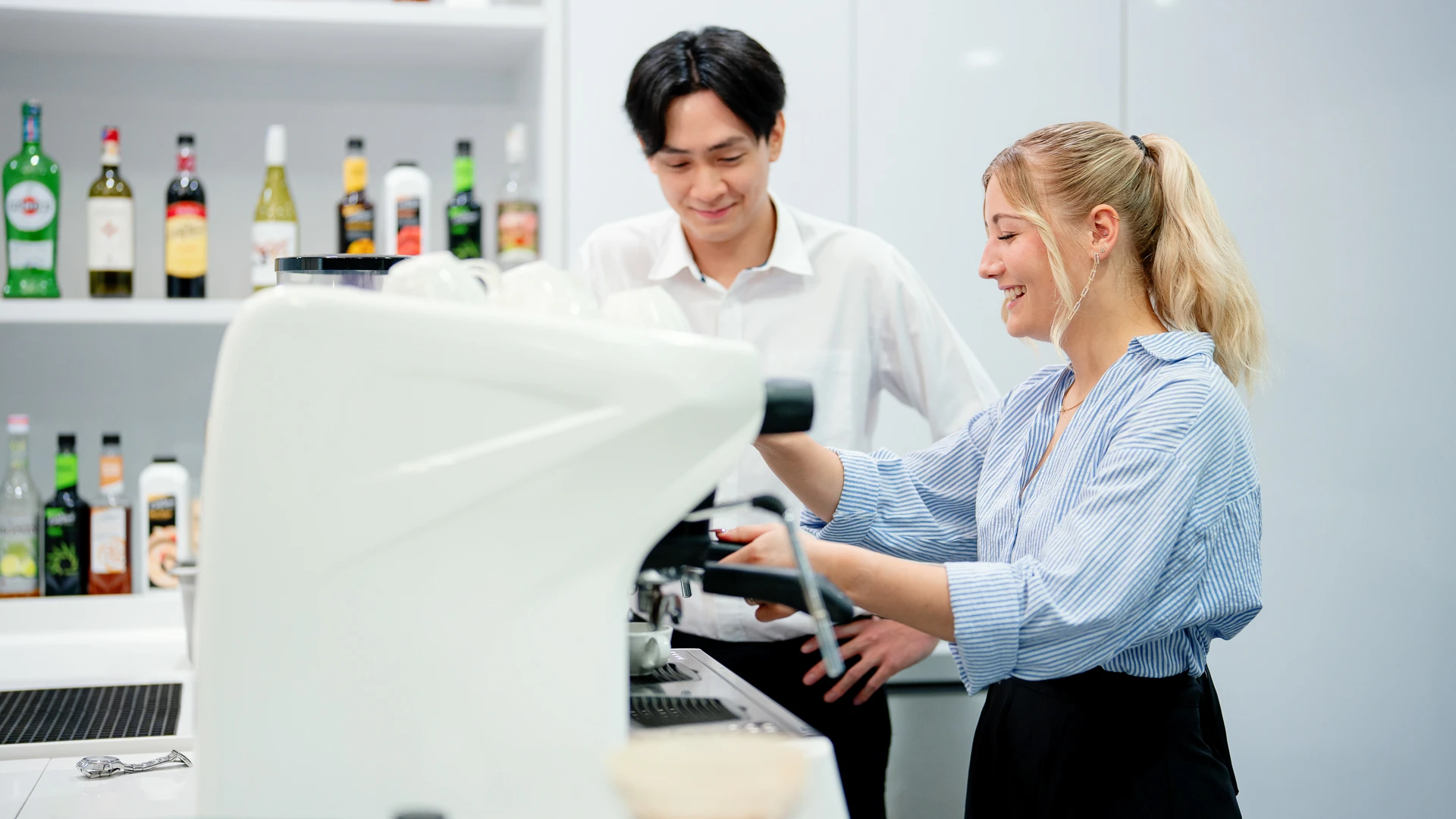 Taylor's student trying on the coffee making machine