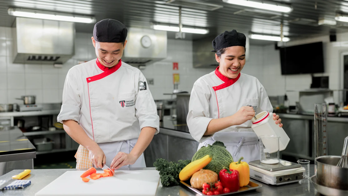 Taylor's hospitality students preparing ingredients in the kitchen