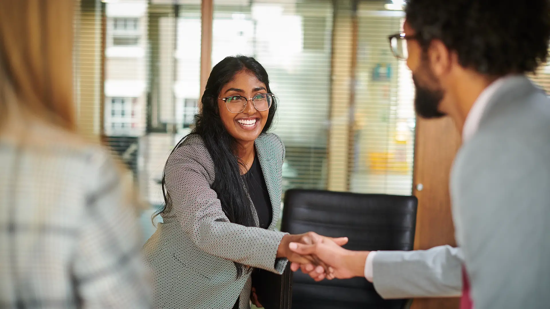 Taylor's law lecturer shaking hand with industry partners