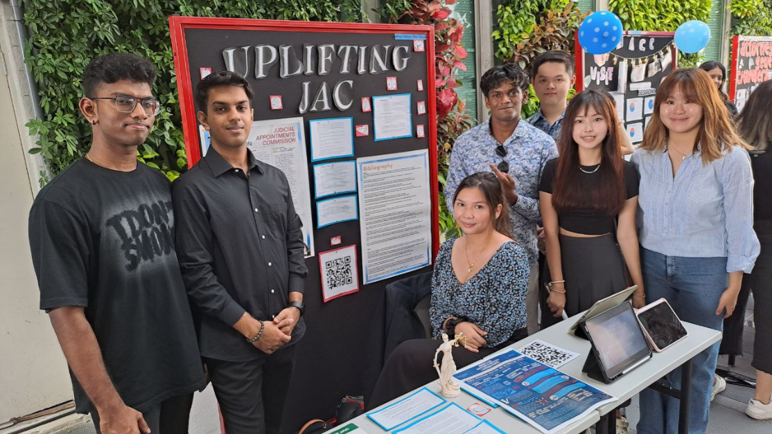 law students manning a booth for the Justice Hub