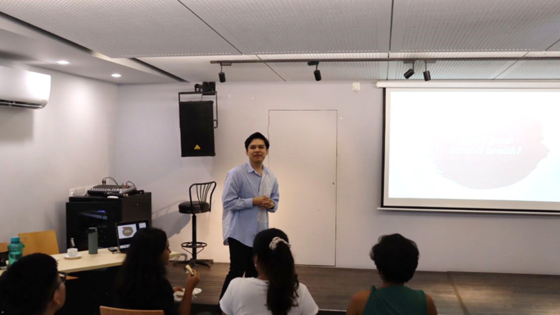 taylors student giving a talk in a classroom