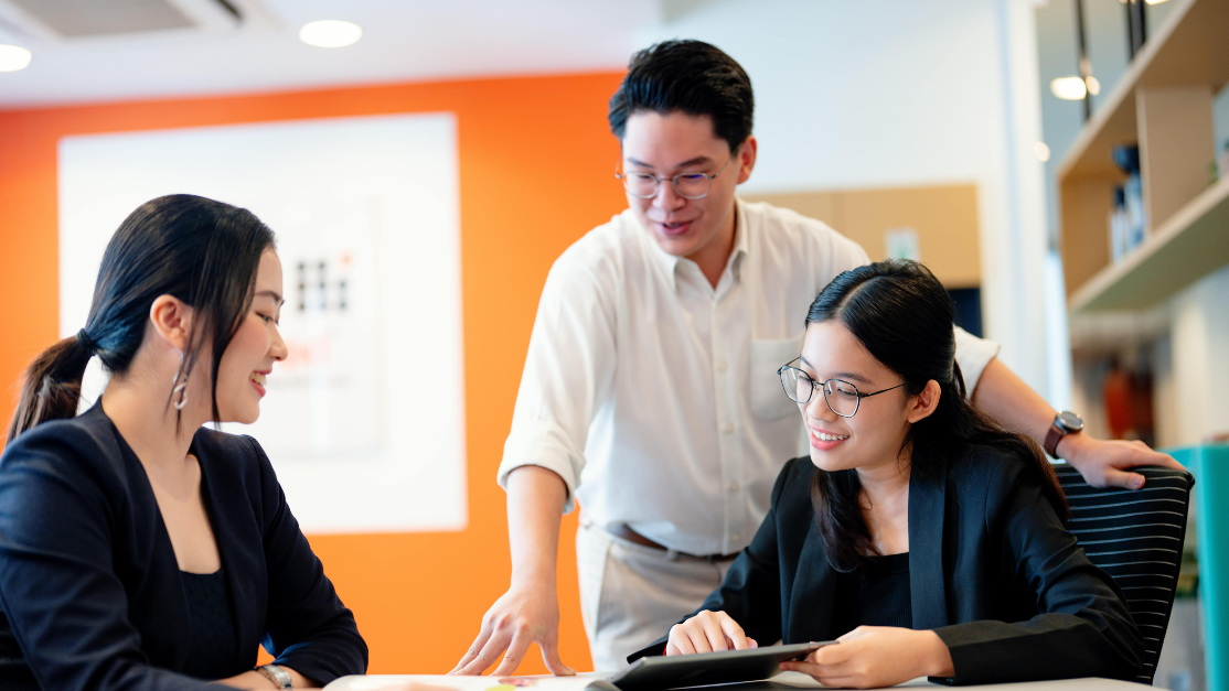 Lecturer and two students discussing about business major project in BizPod disucssion room