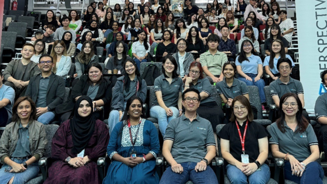 students and lecturers seated in lecture hall
