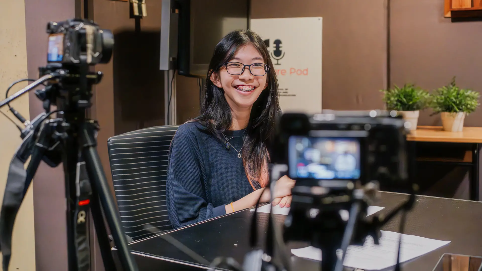 Taylor's student in the studio surrounded by cameras