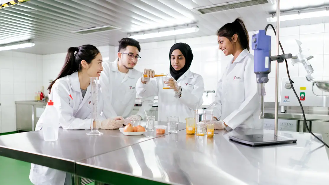 Taylor's student carry out experiment in the lab