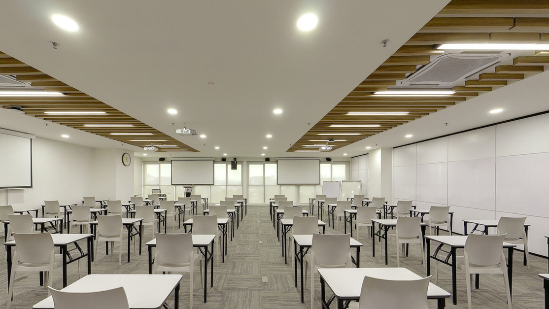Auditorium at Taylor’s Clinical School arranged with tables and chairs facing projector screens