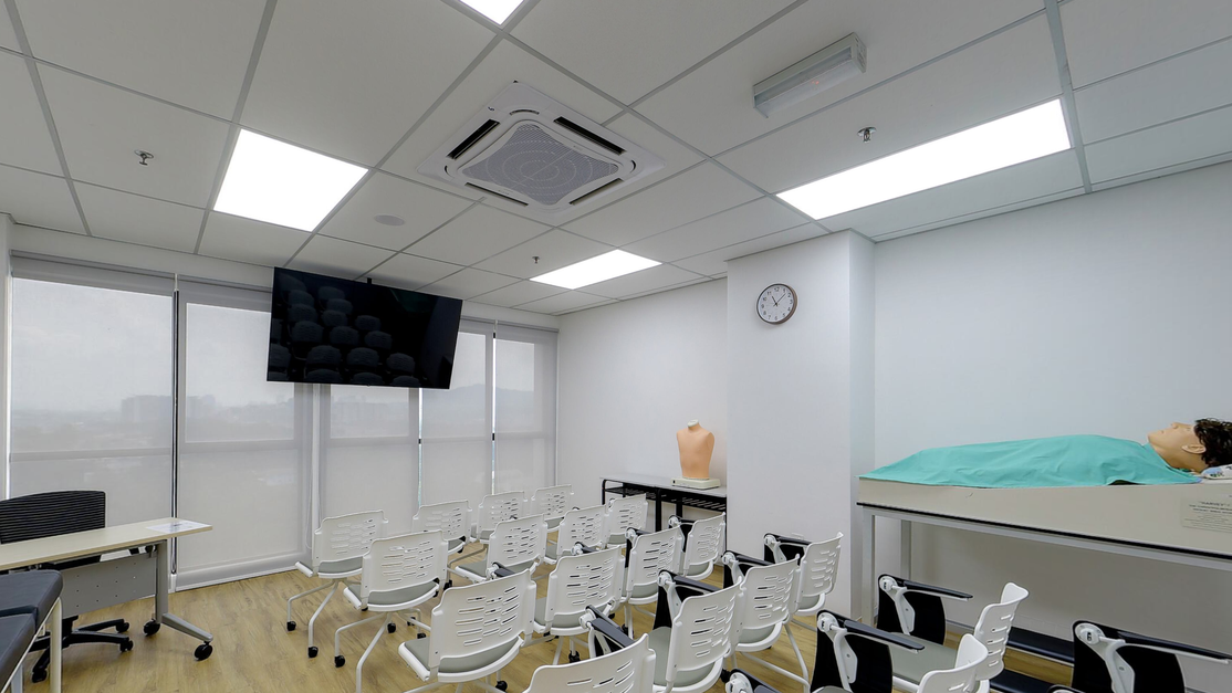 Clinical skills room at Taylor’s Clinical School with a patient manikin on a bed and rows of seats