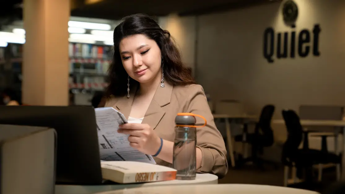 Taylor's pharmacy student doing research in the library