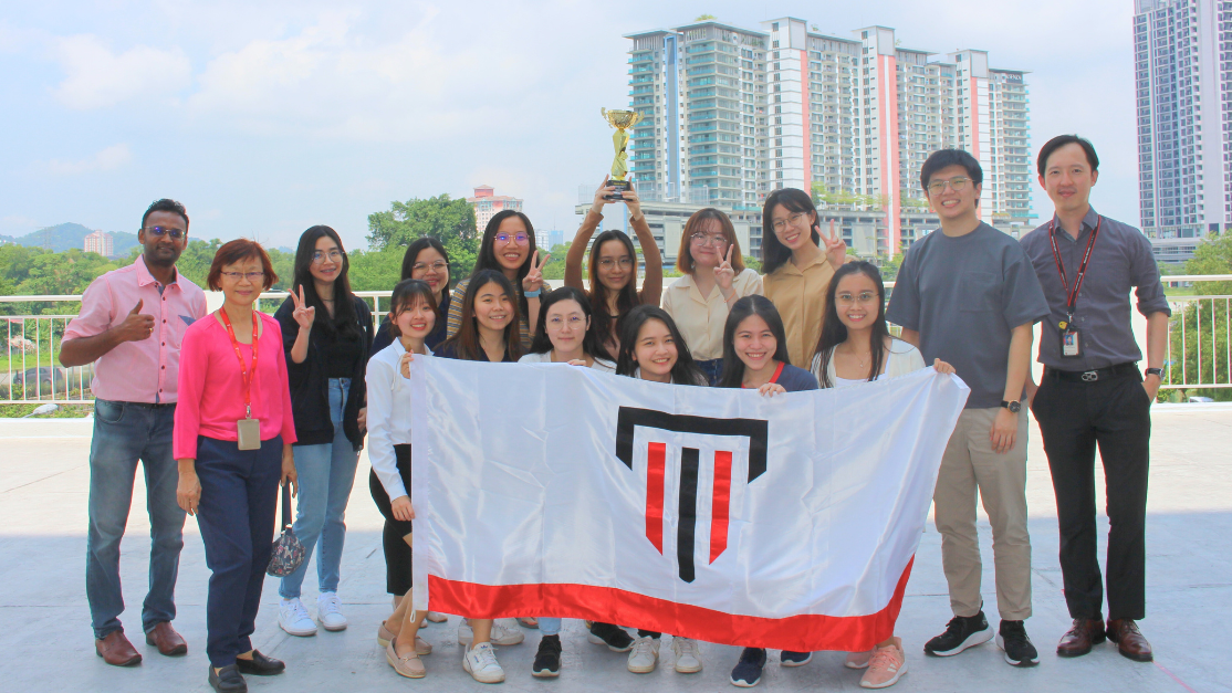 Group of Taylor's Pharmacy Student holding Taylor's Flag celebrating success for competition