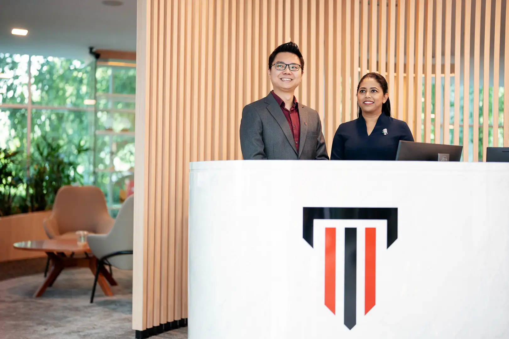 Taylor's liberal arts and sciences lecturer greeting student at the receptionist