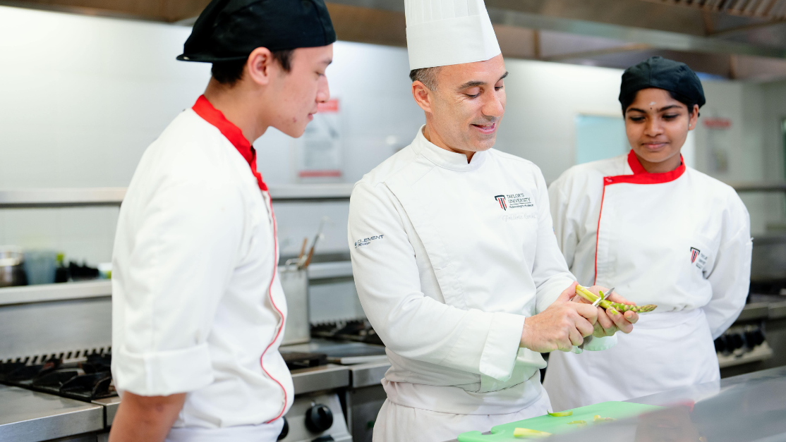 chef lecturer demonstrating cooking to students