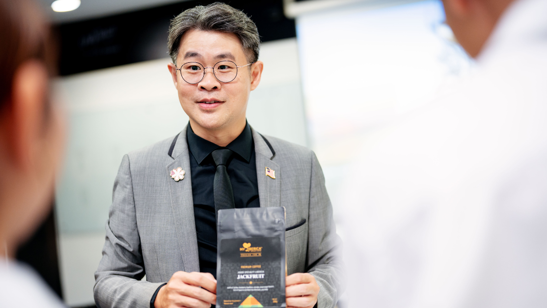 Lecturer showing students a small booklet