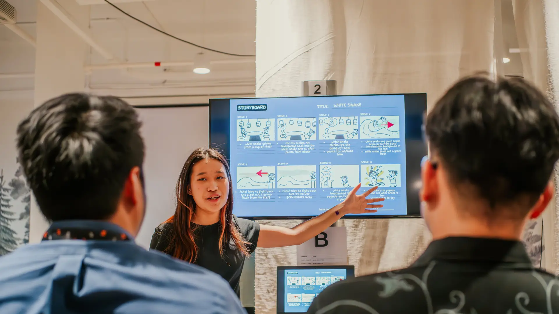 Taylor's design student giving presentation to other students on TV monitor