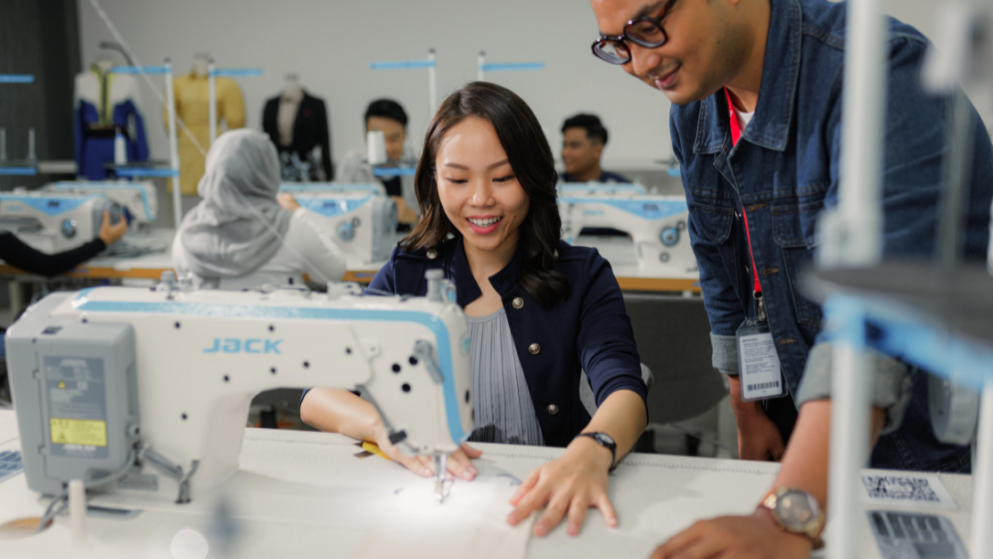 lecturer giving advice to a student on tailoring